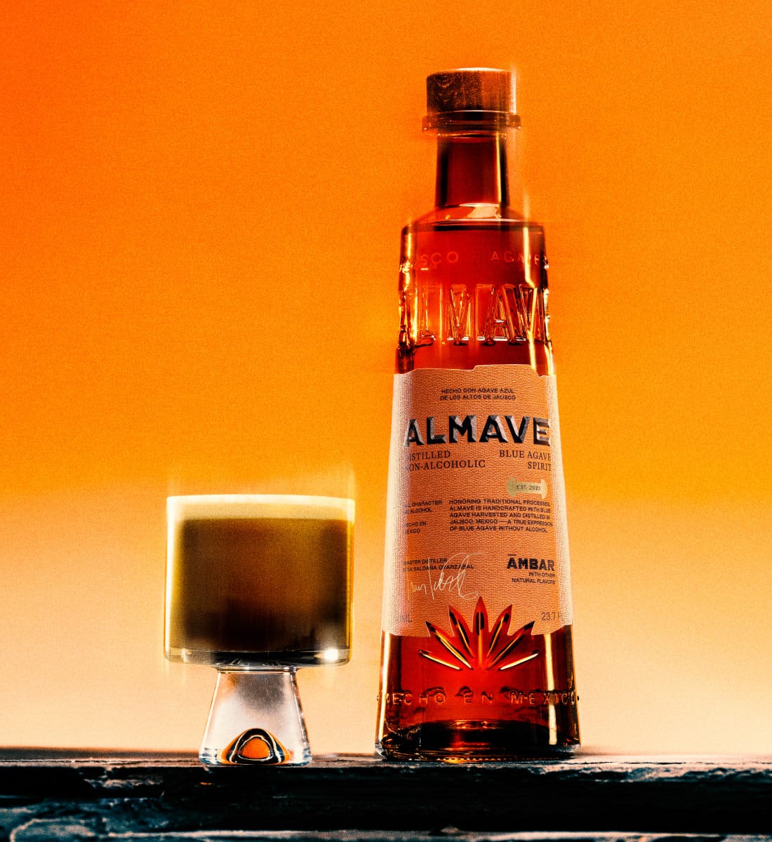 ambar carajillo cocktail next to bottle of almave ambar